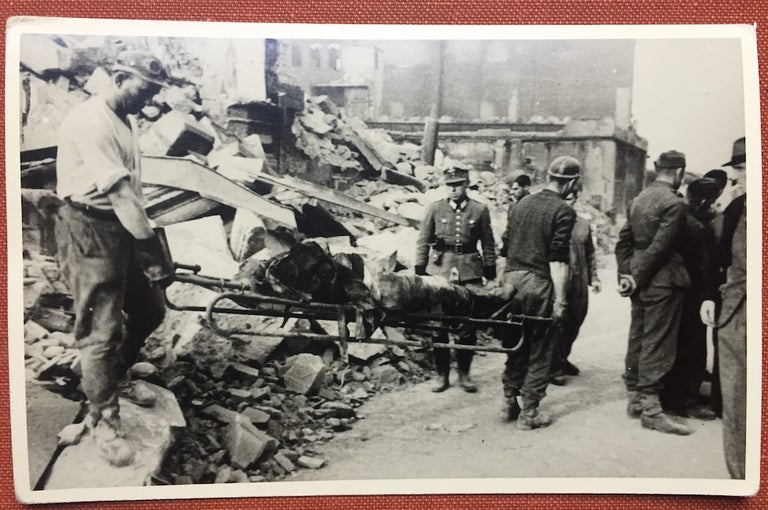 Item #H1132 Real photo postcard of transporting a victim of Hamburg bombing (1943-44) transported on a gurney. Hugo Schmidt, sometimes known as Hugo Schmidt-Luchs.