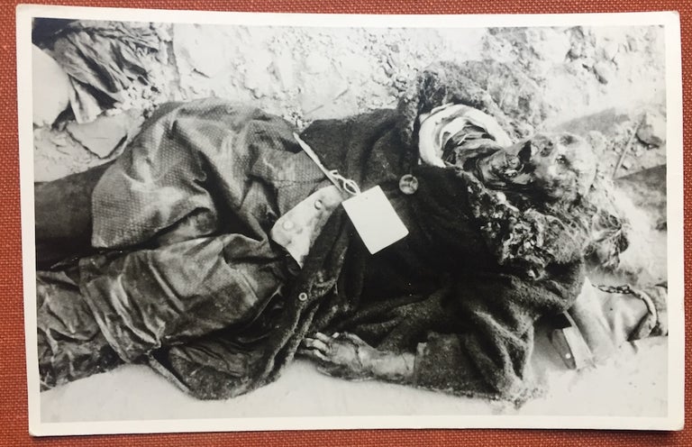 Item #H1133 Real photo postcard of a victim of bombing in WWII, a tagged victim of bombing, probably Germany 1944. N/A.