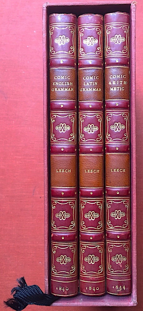 Item #H2727 3 volumes uniformly bound in straight grained red morocco by Bayntun: The Comic Latin Grammar (1840); The Comic English Grammar (1840); Comic Arithmetic (1844) - all first editions. Percival Leigh, John Leech.