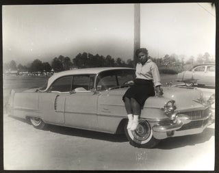 Item #H33653 14 x 11" photo of young Black woman on the hood of a 1956 Cadillac Coupe de Ville....