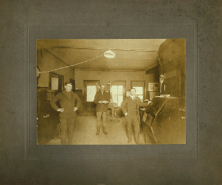 Item #z04446 Photograph of three men in a Pittsburgh post office, ca. 1910. n/a
