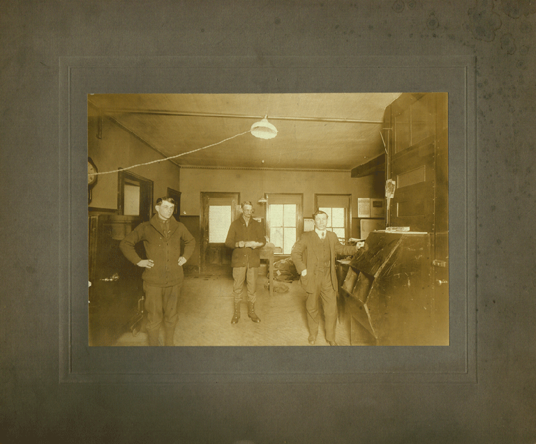 Item #z04446 Photograph of three men in a Pittsburgh post office, ca. 1910. n/a.